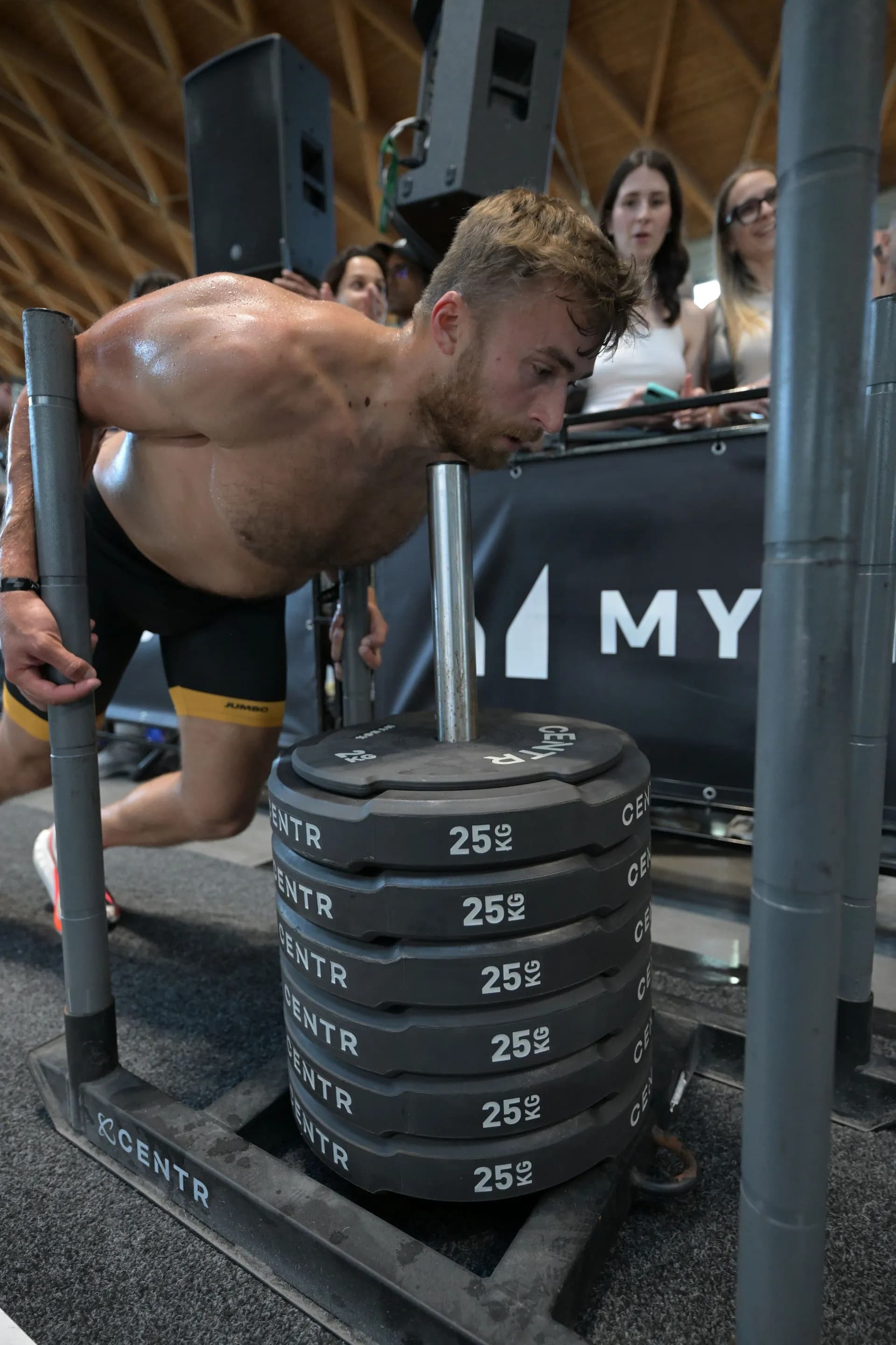 Richard Hynek driving the sled push at a HYROX race
